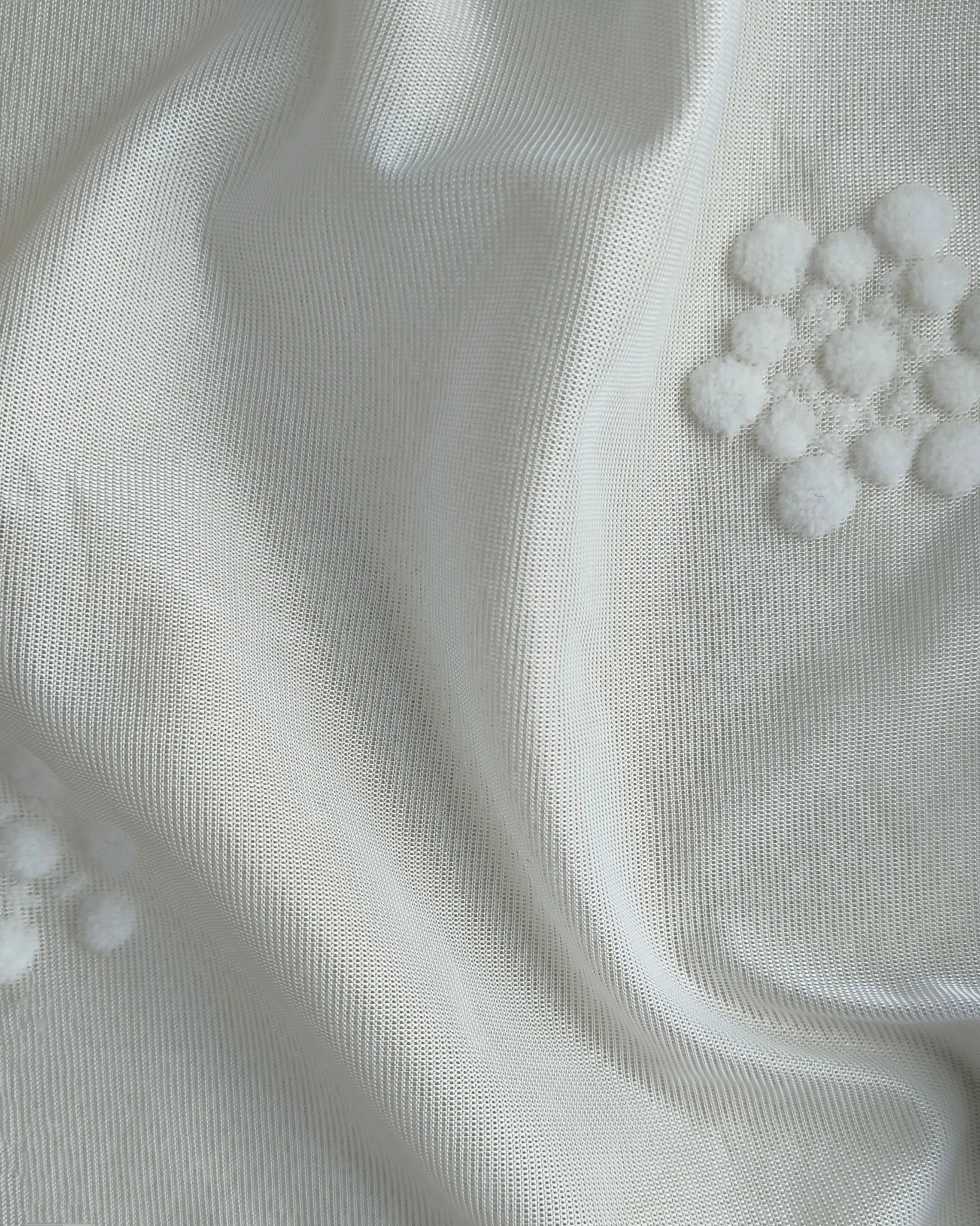 White textured pleated curtains with patterned design, perfect for the living room.