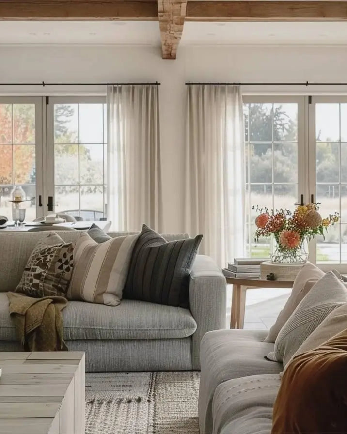 White pleated curtains with black rods, perfect for living room.