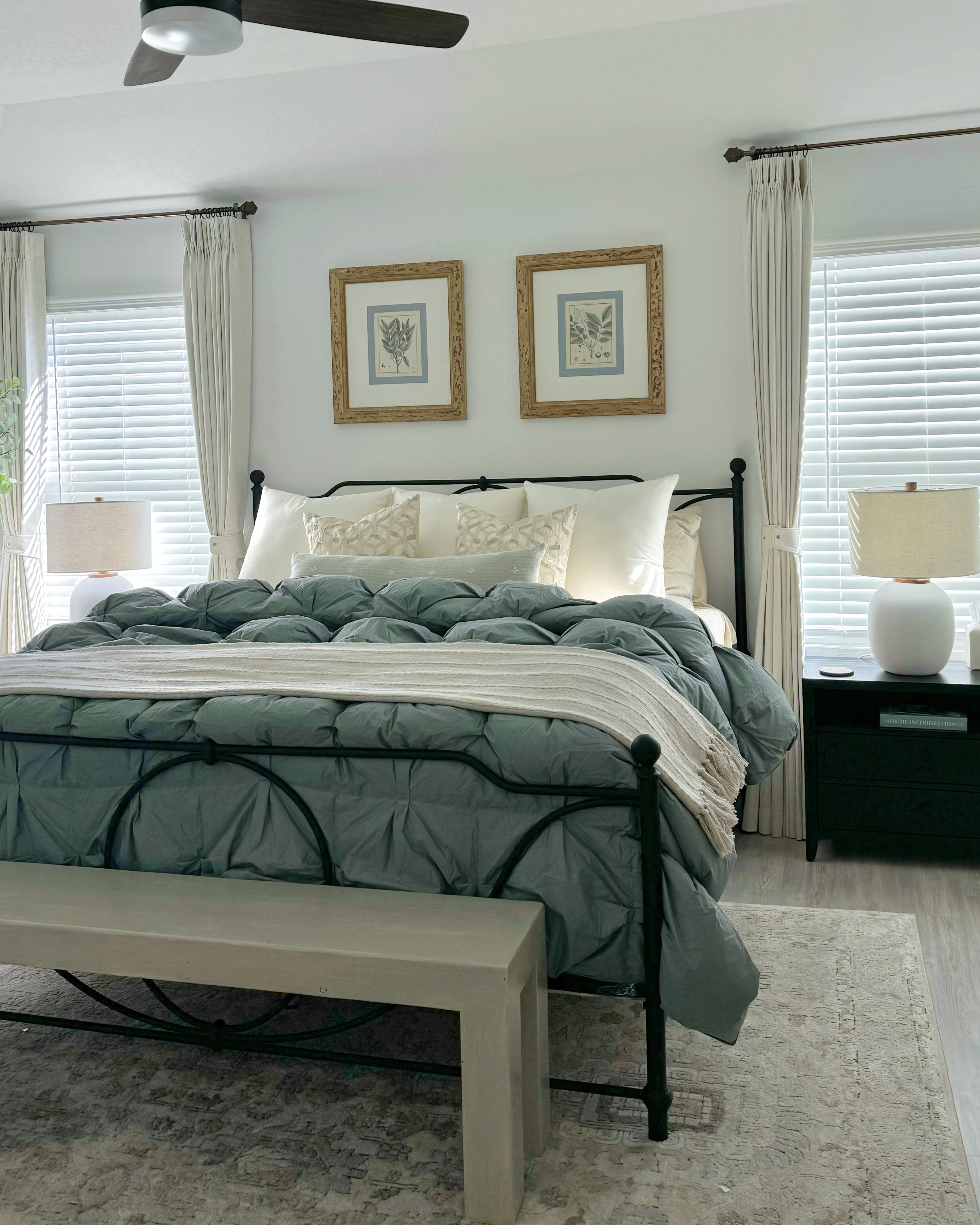 Luxury bedroom with stylish drapery, plush bedding, and elegant decor creating a comfortable and sophisticated atmosphere.