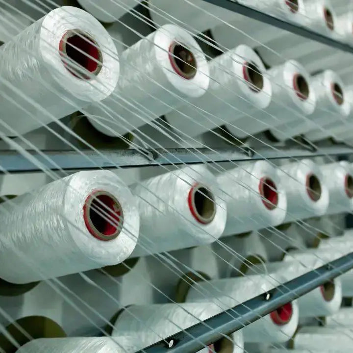 Spools of thread in a textile factory, illustrating the process of how to make curtains.