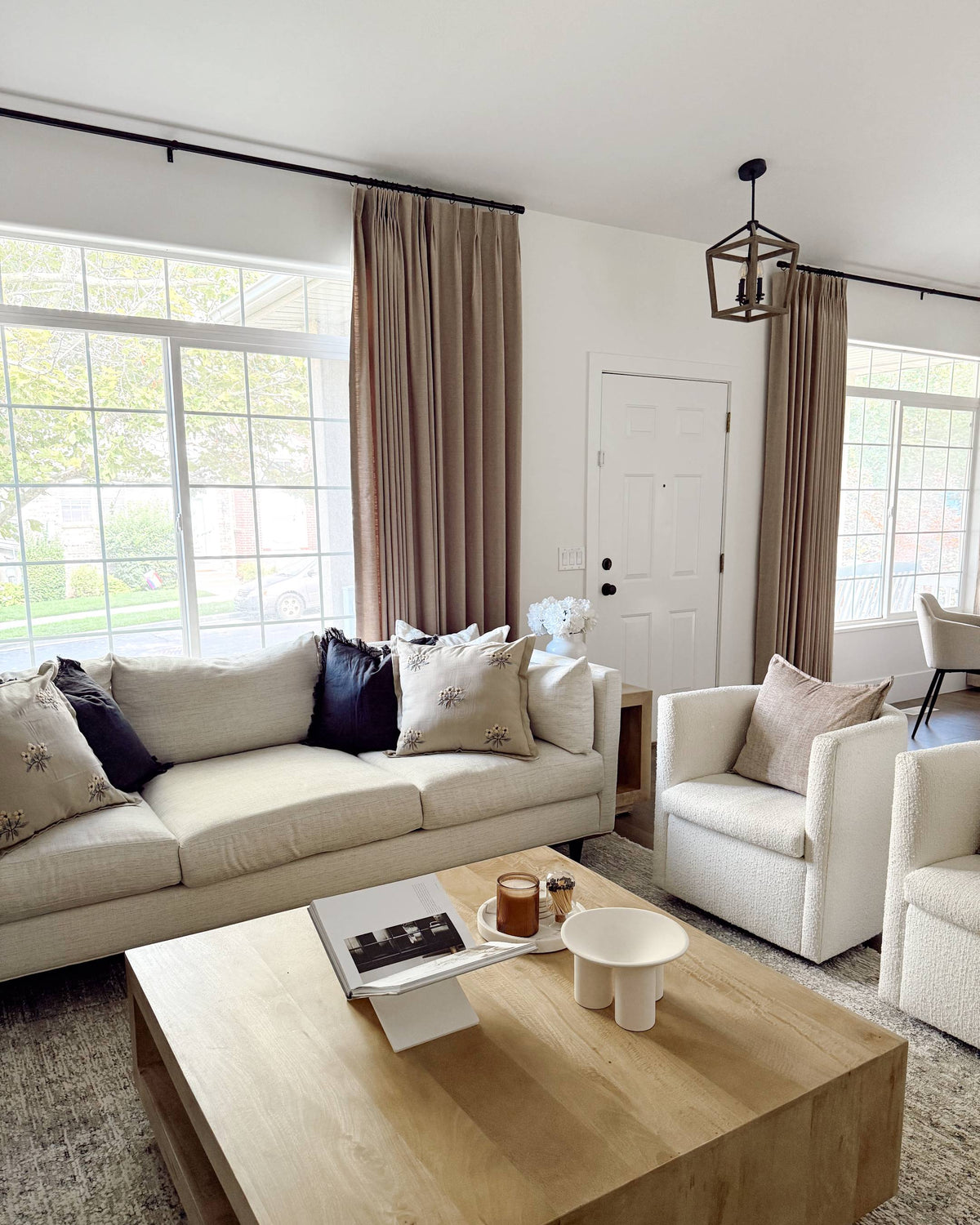 Lena Linen Soft Pebble-L2311 pleated drapery in a bright living and dining room