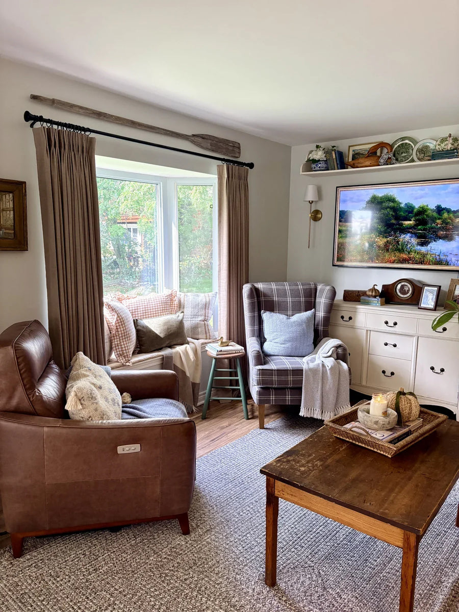Warm taupe curtains framing the bay window in Rebecca's cottage living room