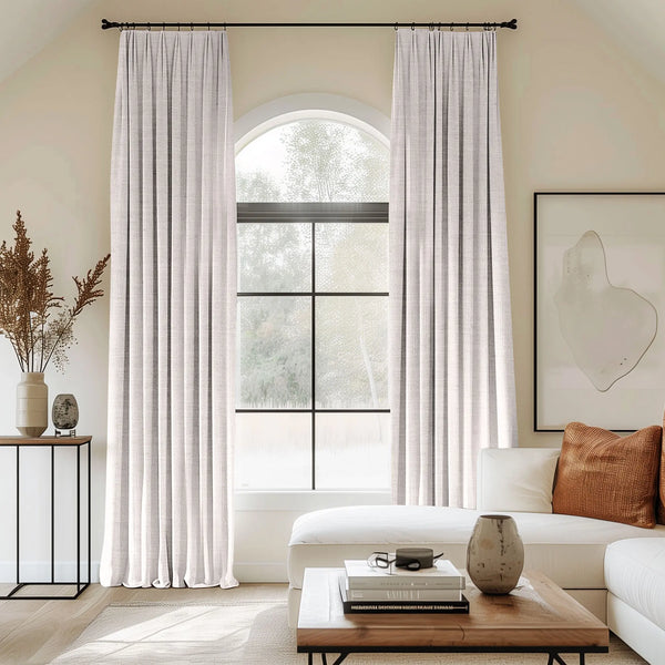 Grey curtains blending linen, cotton, and polyester with black curtain rods, perfect for the living room.