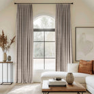 Grey curtains blending linen, cotton, and polyester with black curtain rods, perfect for the living room.