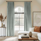 Blue curtains blending linen, cotton, and polyester with black curtain rods, perfect for the living room.