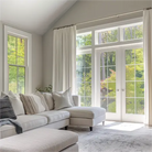 In the living room, white linen pleated curtains are hung on rods.