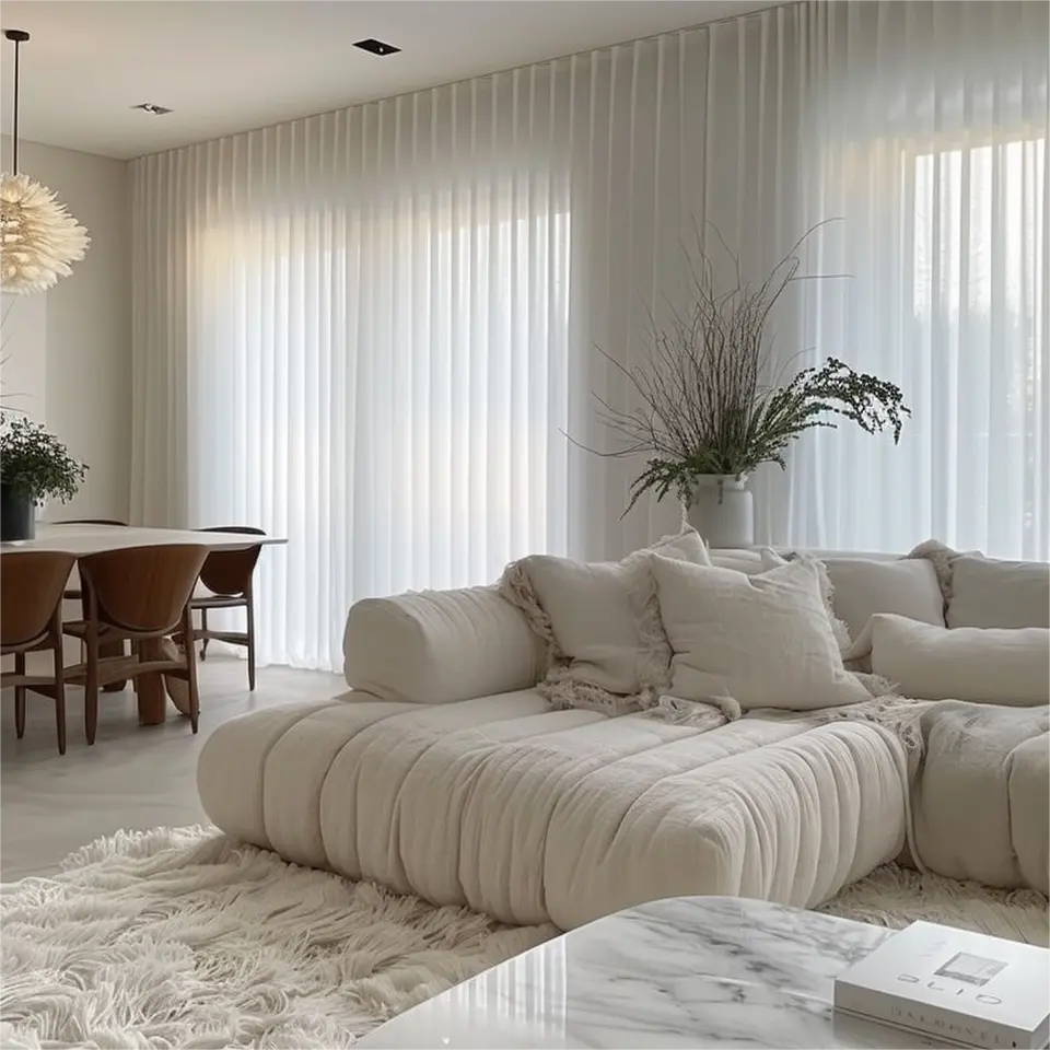 White silk grommet curtains are installed on rods in the living room.