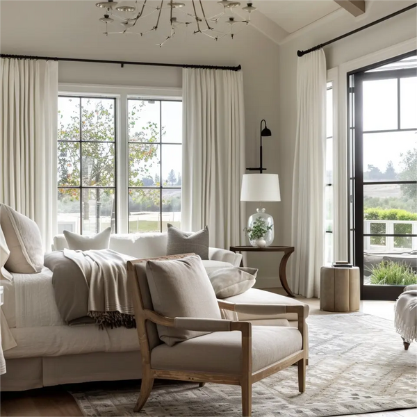 Pleated curtains made of white velvet are installed on rods in the living room.