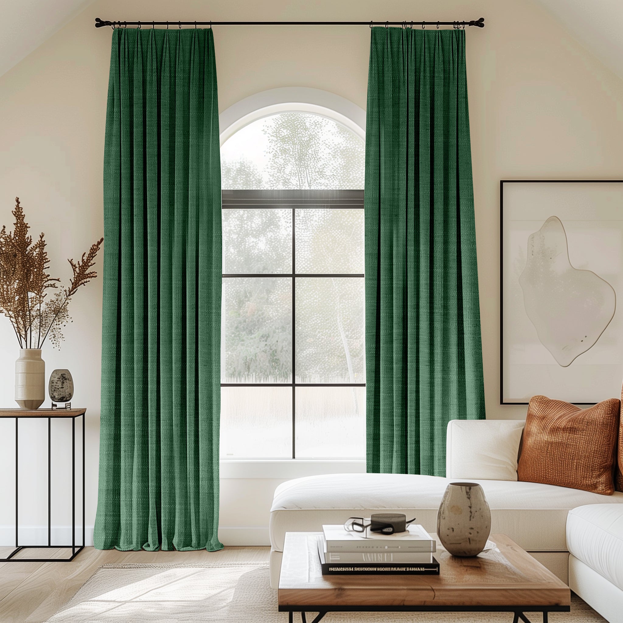 Living room with arched window and green velvet pleated curtains.