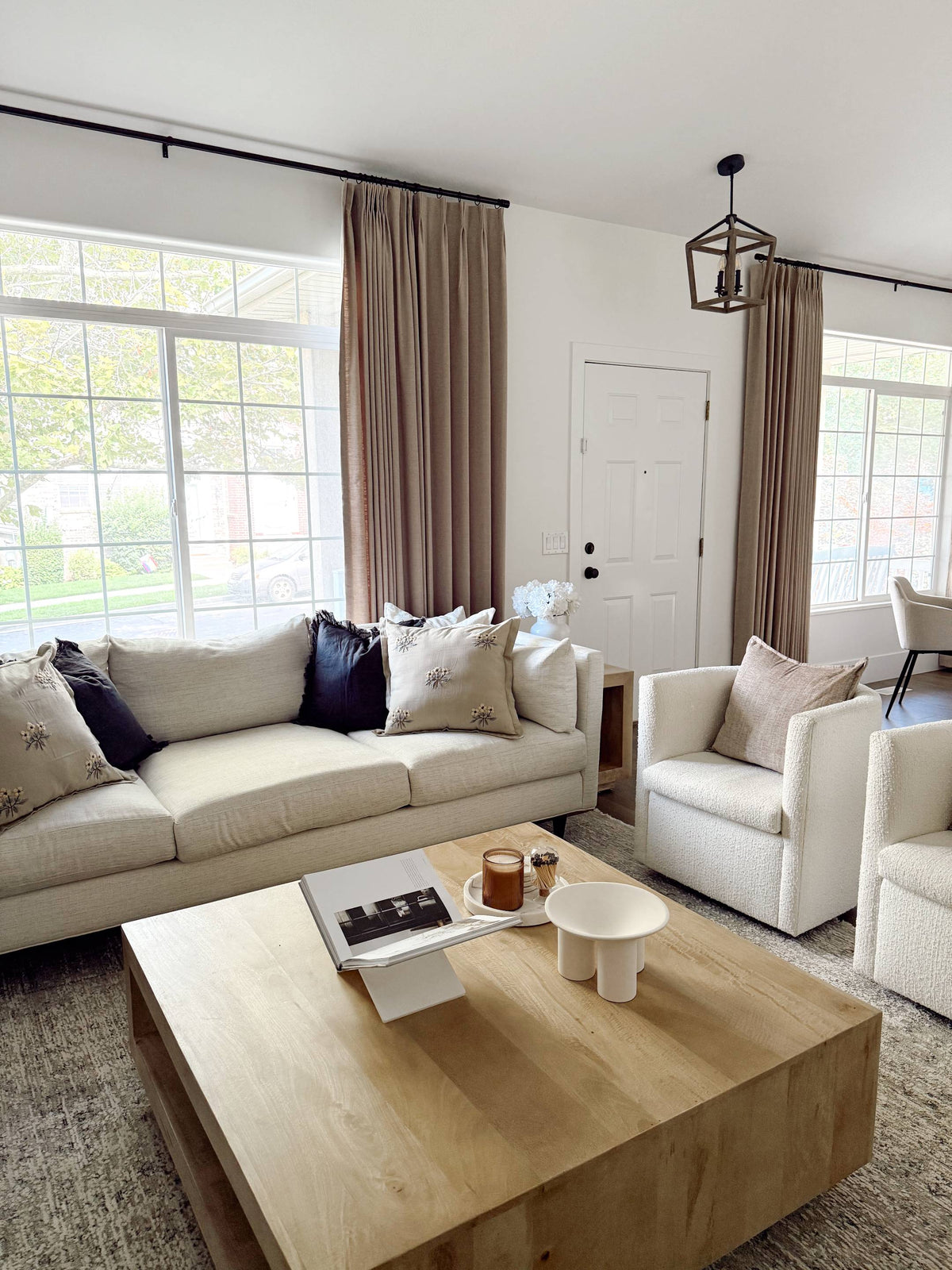 Lena Linen Soft Pebble-L2311 pleated drapery in a bright living and dining room