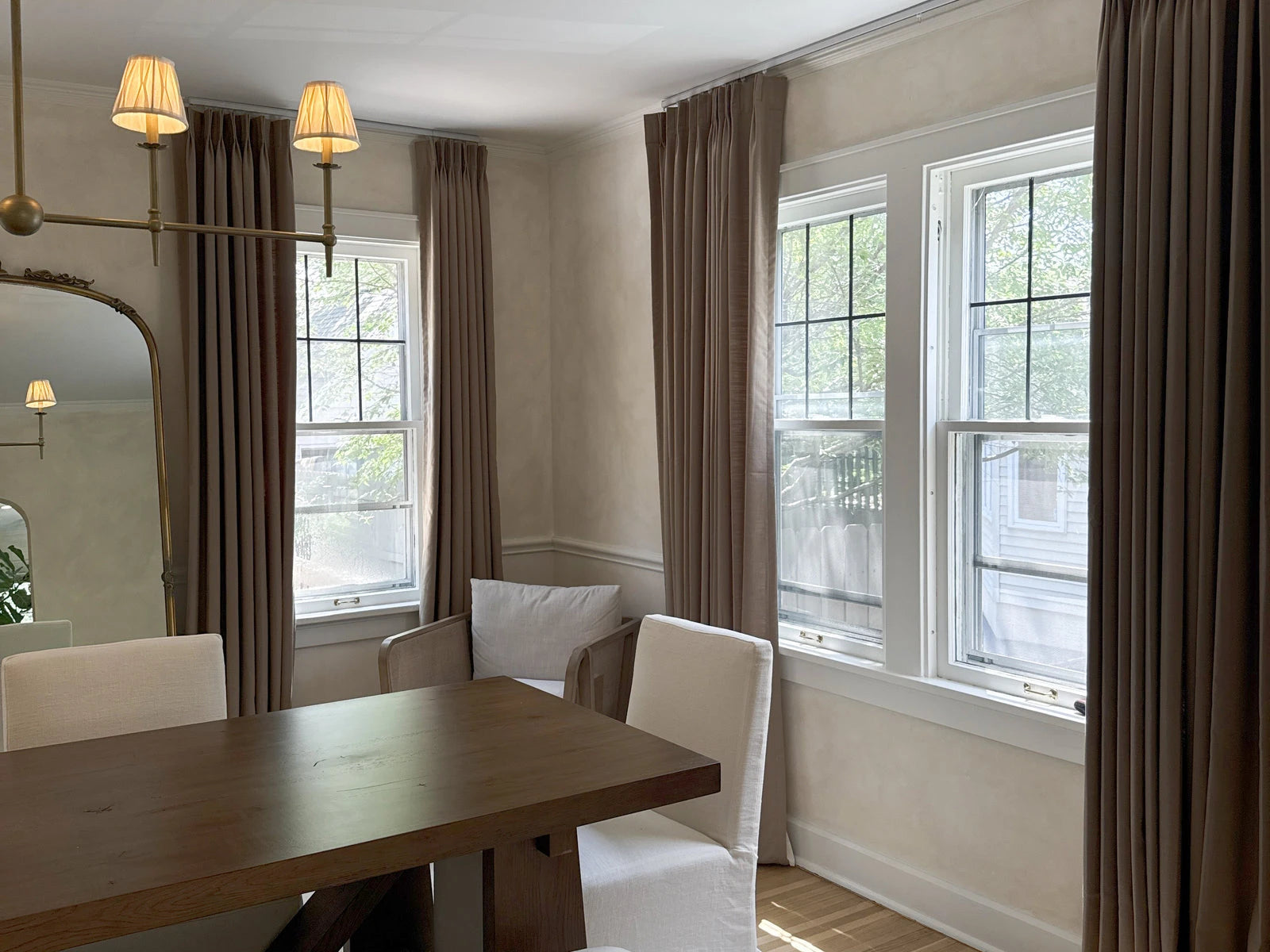 Charred Oak curtains framing a warm Cozyology dining room prepared for guests